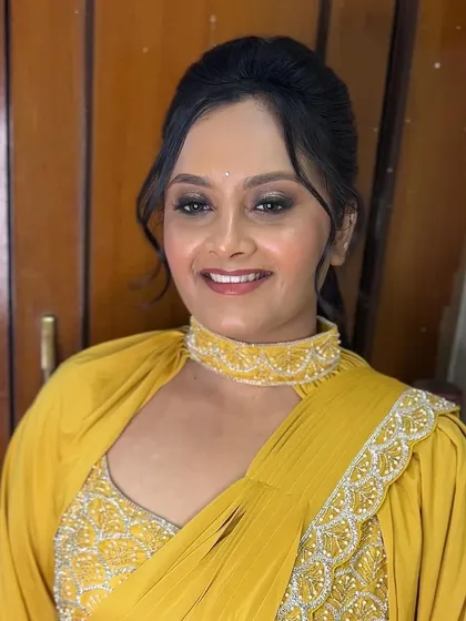 The full look of the modern yellow saree. The choker-style blouse and pre-pleated drape create a very fashionable and easy-to-wear ensemble.