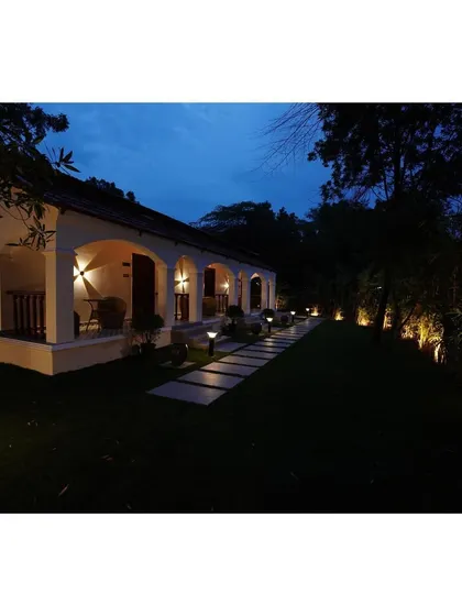 Here is the white arched villa at dusk. The strategic exterior lighting I planned accentuates the architectural form of the arches and illuminates the pathways, creating a warm and inviting ambiance in the evening.