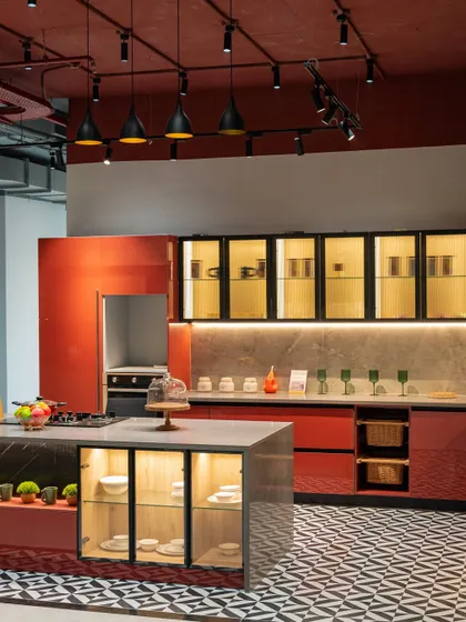 A vibrant red modular kitchen at the Hyderabad Experience Center. This full-scale display helps you visualize how different colors and layouts would work in your own home.