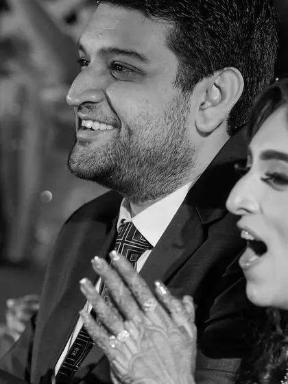 The couple's joyous reactions while watching their loved ones perform on stage. These are the priceless moments that make a wedding.