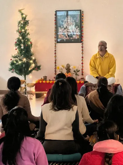 From a back view, the community is seen facing me during a satsang. This perspective highlights the collective nature of our gatherings, where we all learn and grow together.