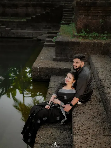 A serene moment by the temple pond (kalyani). The reflection of the palm trees in the water adds a beautiful, peaceful element.