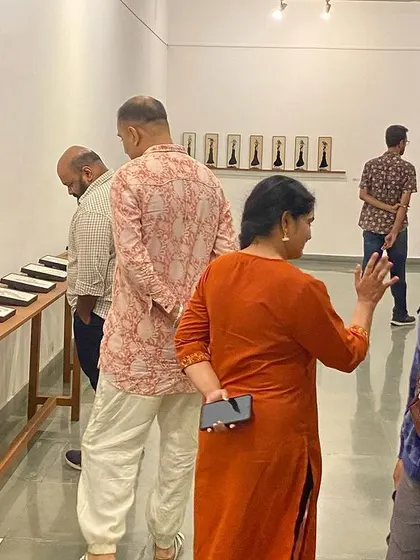 A visitor at the opening of 'Quieter than Silence', smiling for the camera.