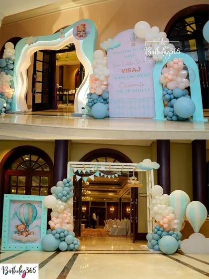 The grand entrance to a hot air balloon and teddy bear-themed party, with beautiful balloon arches and a personalized welcome sign.