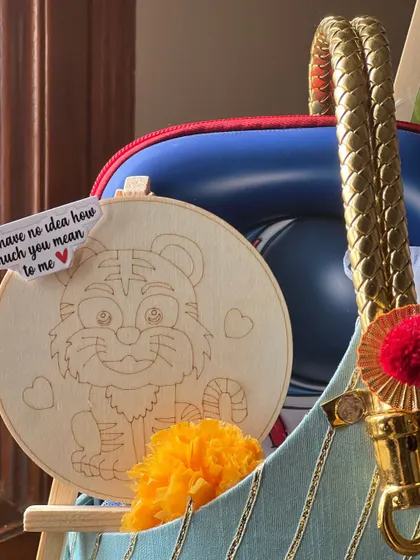 A close-up on the personal touches, like this wooden tiger craft with a note that reads, "You have no idea how much you mean to me."