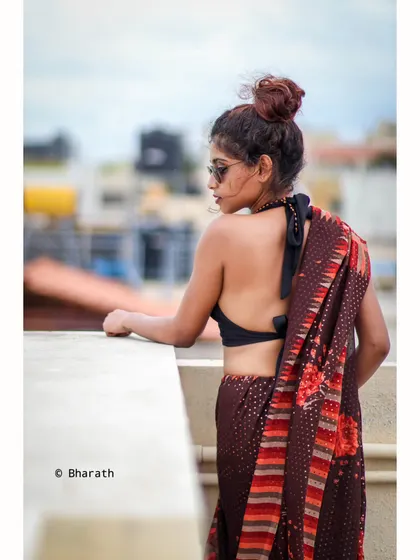 A profile shot on a rooftop, looking out over the city. This creates a thoughtful and atmospheric traditional portrait.