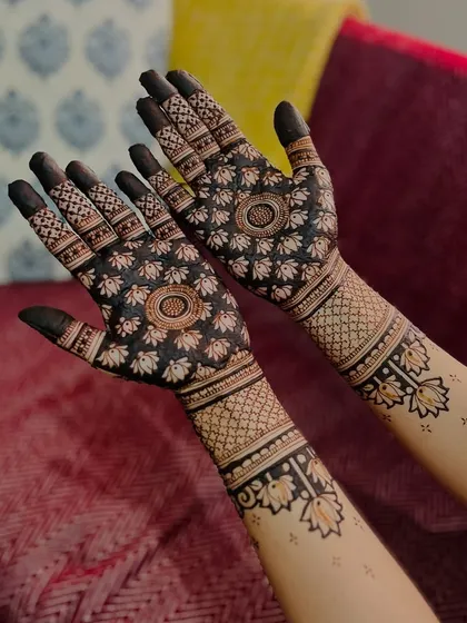 Another angle of the lotus mandala design, this time against a colorful couch. This shows how the mehendi looks beautiful in any setting.
