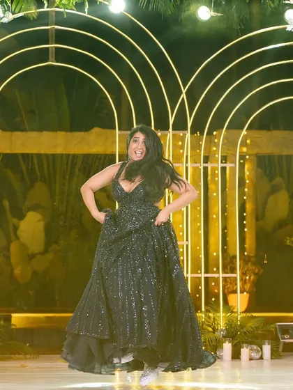 The bride's high-energy solo moment during their love story performance, full of expression and joy.