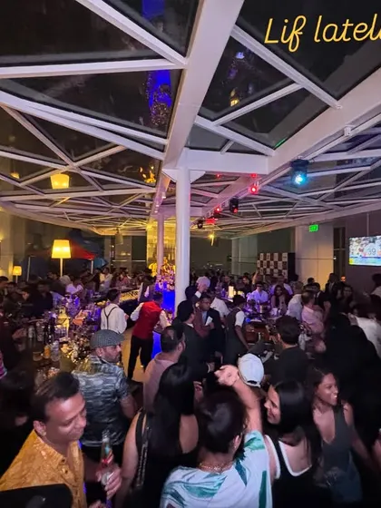 A wide shot of a packed rooftop party at Shangri-la, Bangalore. I specialize in curating sundowner sets that build into high-energy nights.