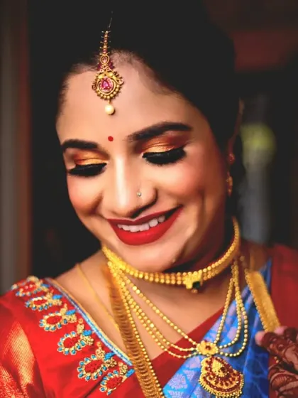A close-up of the baby shower makeup, showing the happy smile and the beautiful golden-orange eyeshadow.