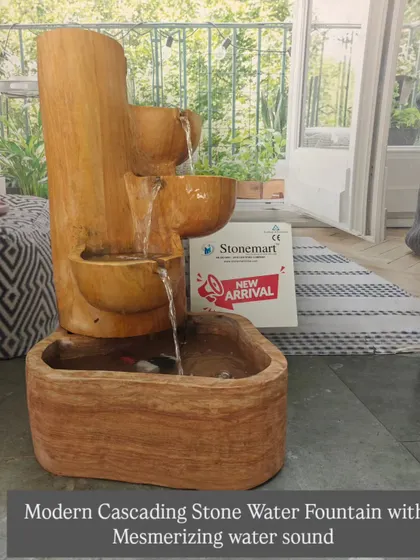 The modern cascading fountain in Teak Sandstone, shown with its mesmerizing water flow. The design directs water through three carved bowls into the main reservoir.