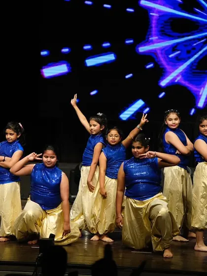 The final pose of the kids' Bollywood performance, a moment of triumph and pure fun. They owned the stage!