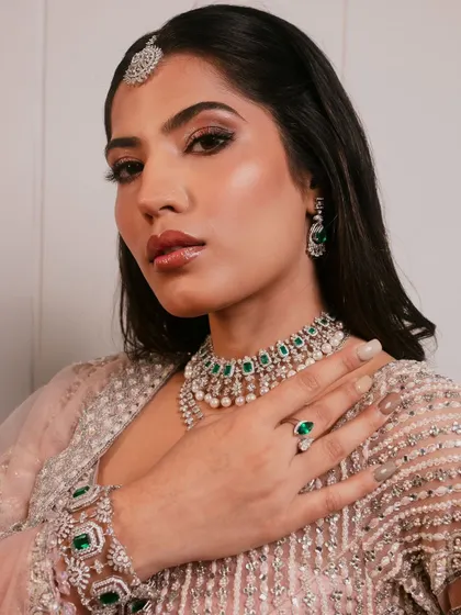 This shot highlights the beautiful hand jewelry and the overall elegance of the modern bridal look.