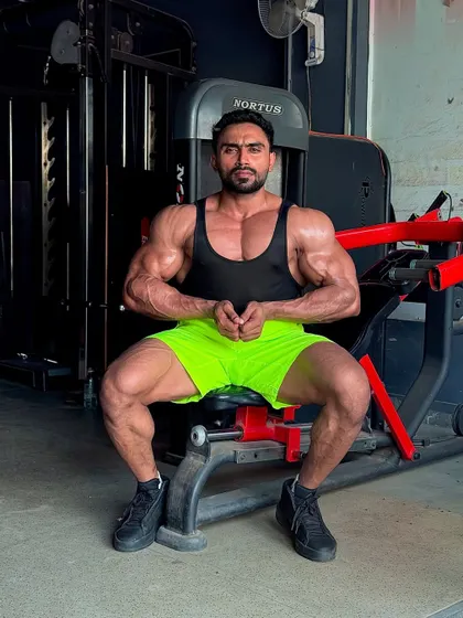 Another seated pose, showing the chest and arm fullness.