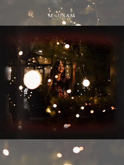 A magical Mehendi portrait. The bride is framed by twinkling bokeh lights, creating a dreamy and festive atmosphere that perfectly captures the excitement of the wedding season.
