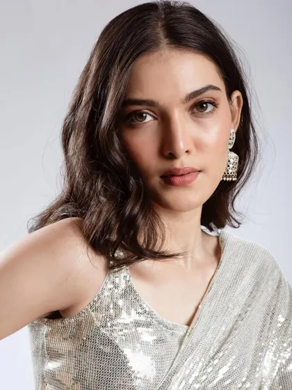 A direct, close-up portrait showing the subtle shimmer on the eyelids and the overall fresh, dewy finish of the skin.