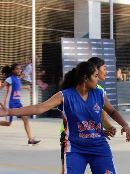 An athlete in our girls' program positions herself on defense, communicating with her teammates. We foster a team-first mentality where every player understands their role and contributes to the group's success.