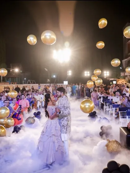 A fairytale first dance on a cloud of smoke, surrounded by floating golden balloons. We turned their Sangeet dance floor into a dreamscape.