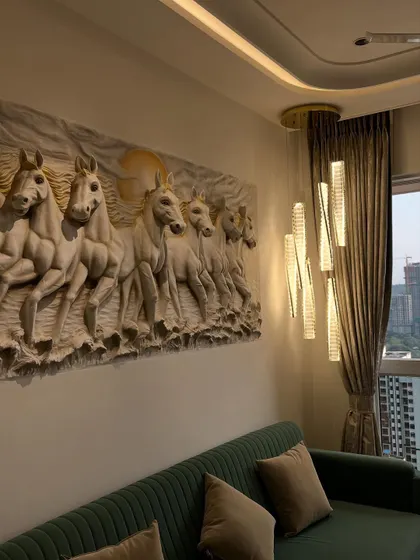 An angled shot showing how the relief sculpture interacts with the room's ambient and decorative lighting, creating beautiful shadows that emphasize its 3D form.