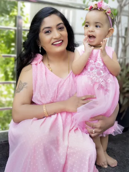 An outdoor shot from the Mother's Day session, capturing a candid and joyful moment between mother and daughter.