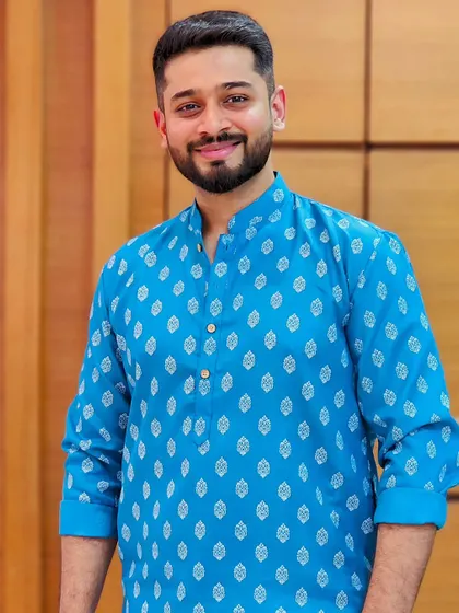 A clean, bright, and friendly look in a classic blue kurta. This image is perfect for ethnic wear brands looking for a model who can represent everyday traditional fashion with a warm and approachable smile.