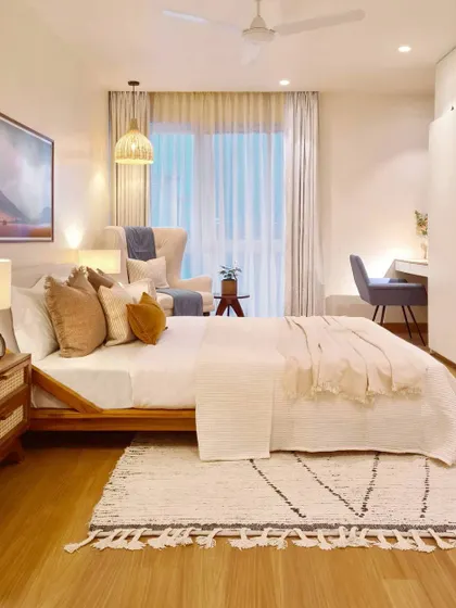 The master bedroom in the Breeze Home was designed to be a true retreat. With a calm color palette, layered textiles, and soft lighting, it's a soothing space to escape to at the end of a long day. The design includes a reading corner and a dedicated work-from-home nook.