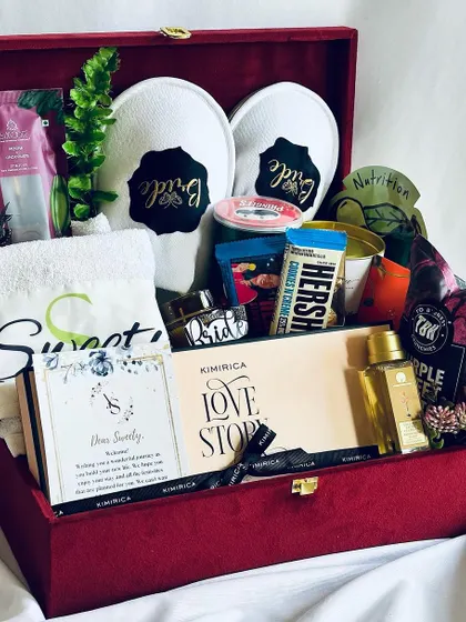 The ultimate bridal hamper, shown here without the ribbon. The rich red velvet box and its contents, including "Bride" slippers and a personalized towel, speak for themselves.