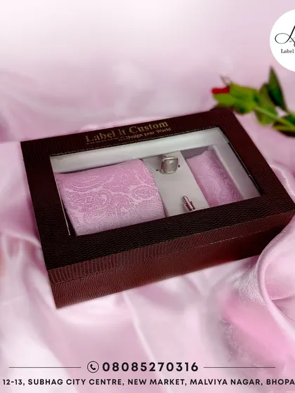 This accessory set features a soft pink paisley tie and pocket square with matching cufflinks. These exquisite details are designed to elevate your style and add a touch of personality to your formal wear.