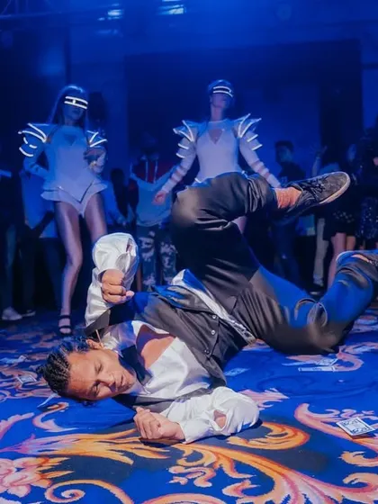 A dancer strikes a pose mid-move, showcasing the high-energy entertainment I arrange to keep the party going all night long.