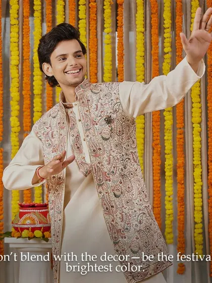 This Diwali, don't blend with the decor, be the festival's brightest color. This off-white kurta with a stunning embroidered jacket is perfect for adding sophistication to your celebrations.