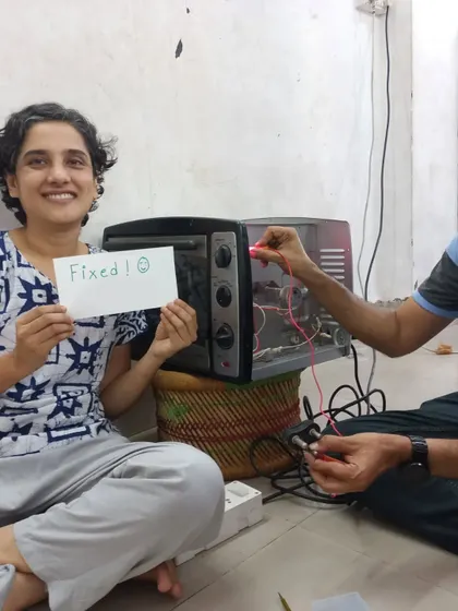 The best feeling in the world: Fixed! A happy participant proudly shows off her repaired oven. Our goal is to empower you with the skills and confidence to fix your own belongings, saving money and reducing waste.