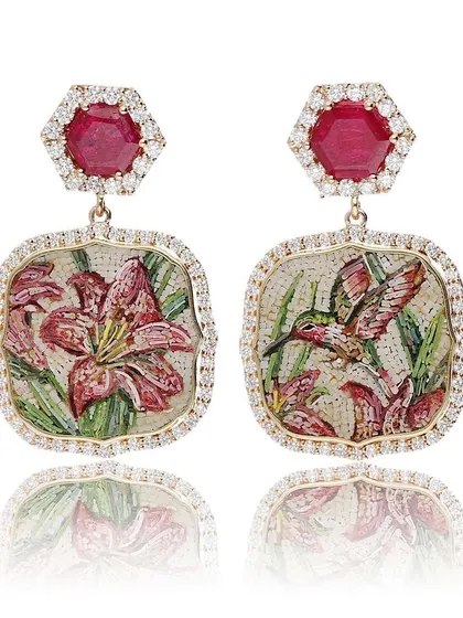 These earrings are inspired by the fluttering wings of a hummingbird. One earring shows the bird poised to take nectar from lilies, while the other shows the bloom, creating a sense of motion and anticipation.