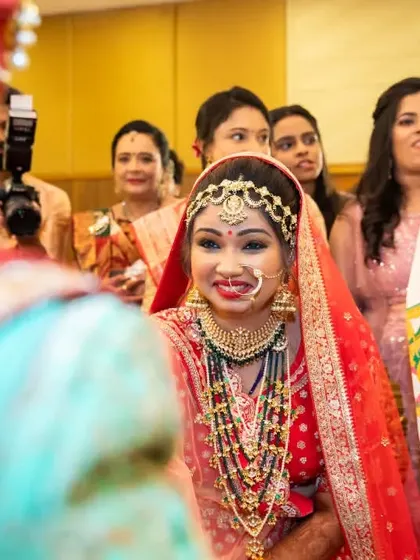 The first look. The bride's beautiful smile as she sees her groom for the first time when the antarpat is lowered.