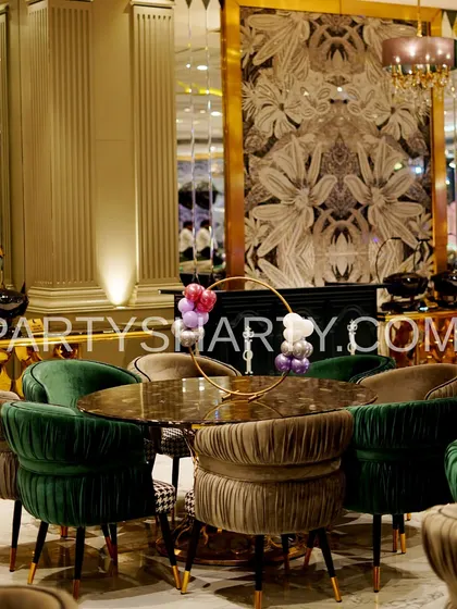 An example of our elegant table decor, with a simple balloon hoop centerpiece on a table with plush velvet chairs, suitable for a sophisticated princess party.