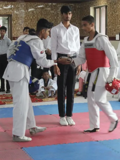Respect is a core principle of martial arts. Here, two competitors show sportsmanship before their match, a value I instill in all my students.