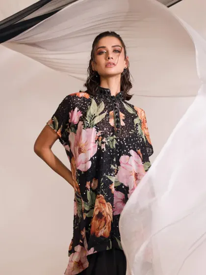 The LIANA Kurti Set, captured with flowing fabric to emphasize its glamorous and sophisticated nature.