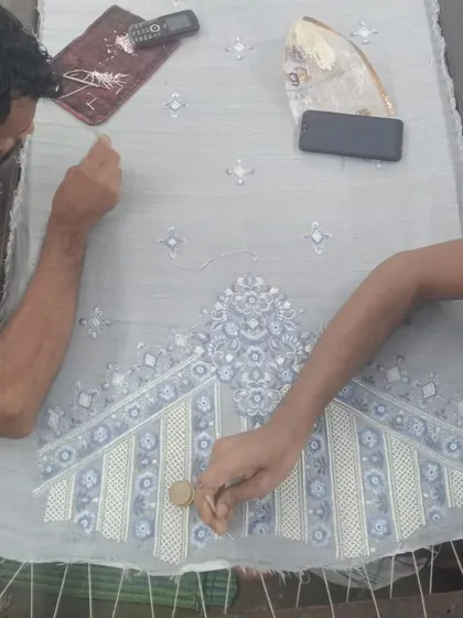 A glimpse into the heart of my craft. Here, my master artisans are meticulously hand-embroidering a piece inspired by Pietra Dura art. Every stitch is a testament to the tradition and dedication that goes into creating a truly bespoke garment for you.