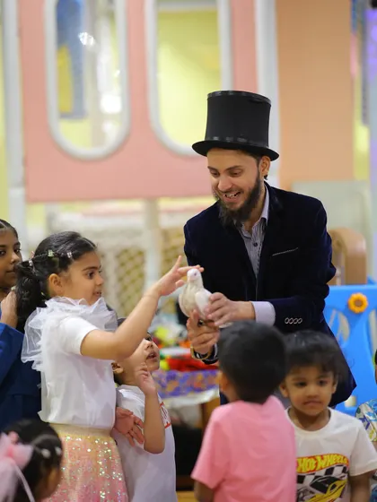 A magician performs for the children at the construction party, showing that a touch of magic fits in perfectly with any theme.