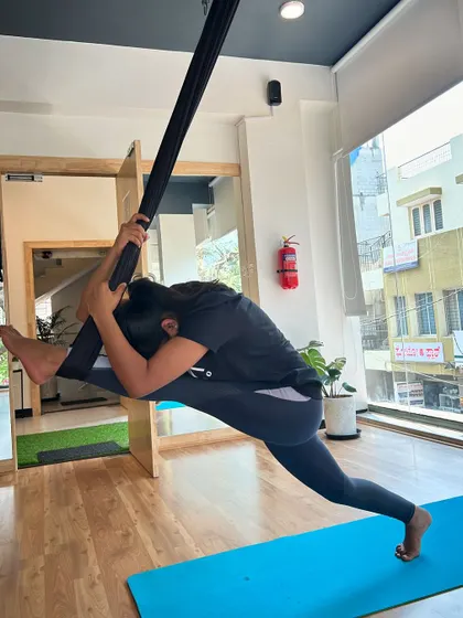 A deep split achieved with the support of the aerial silk, allowing for a safe and effective stretch.
