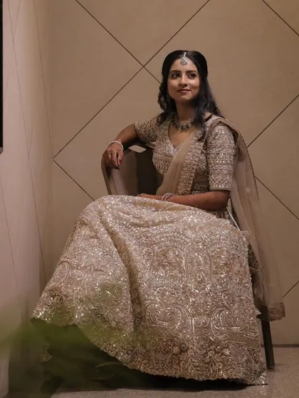 A full view of a stunning reception lehenga look. I focused on creating a luminous makeup style that complemented the intricate silver embroidery of her outfit.