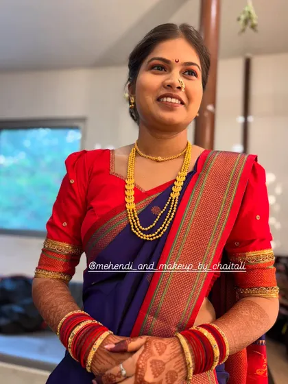 A complete traditional look for a wedding guest, featuring soft makeup, a classic bun hairstyle, and expert Nauvari saree draping. My goal is to create an elegant and comfortable look for family members.