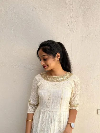 A closer look at the detailed neckline of the cream ethnic dress.