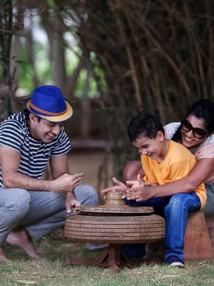 This happy family moment captures the fun of learning pottery together. It's an activity that engages all ages and creates wonderful, tangible memories.