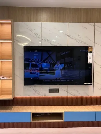 Another view of the blue and wood TV unit, showcasing the ample storage and the beautiful contrast between the different materials and finishes.