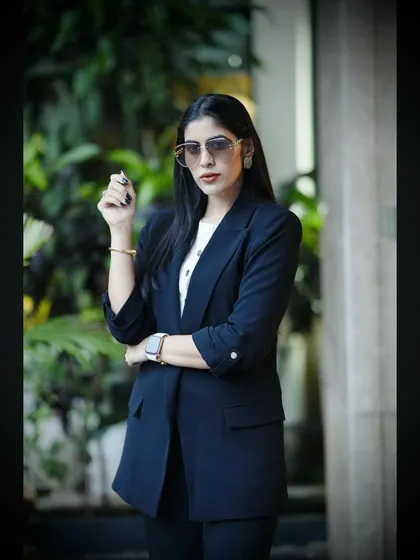 The combination of a power suit and a confident stance is a key part of my brand. It visually represents the successful, modern businesswoman persona.