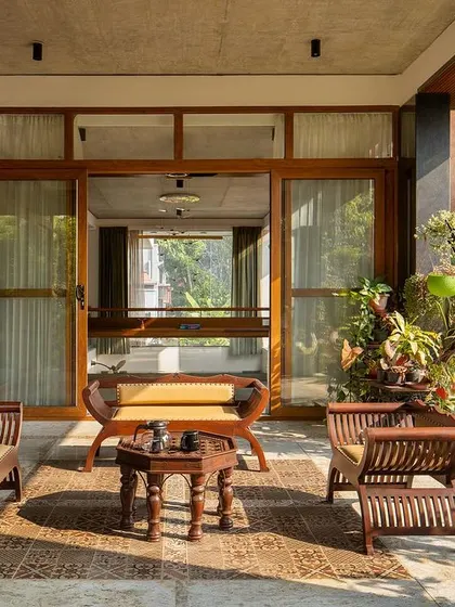 The ground-floor seating pavilion, a perfect example of indoor-outdoor living, nestled amidst the garden.