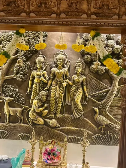 This shot focuses on the beautiful Ram Darbar relief, framed by our traditional floral decor. It's an honor to decorate such a central and sacred part of a new home.