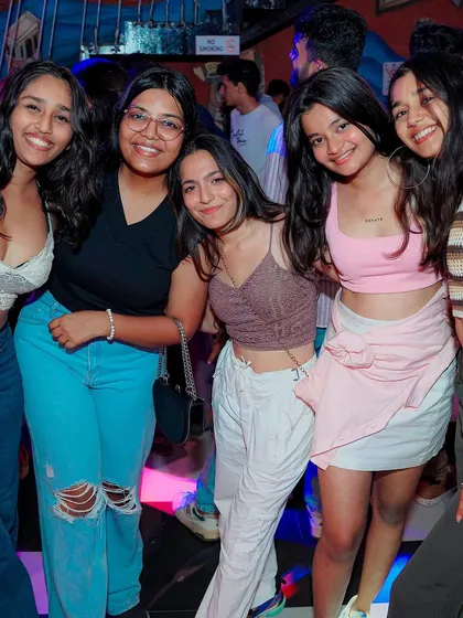 A group of girls smiling for the camera at Bombay Adda. It's all about creating a fun and safe environment for a great night out.