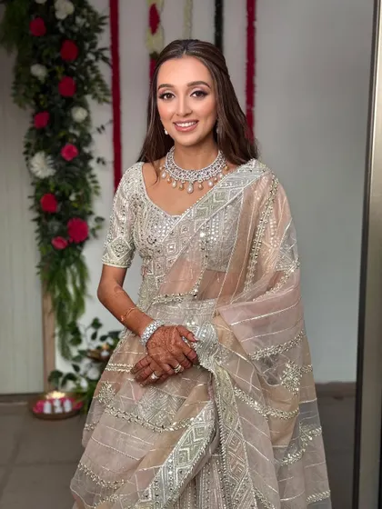 The beautiful bride-to-be, seen from the front. Her half-up hairstyle keeps the hair away from her face, allowing her radiant smile and stunning diamond necklace to take center stage.