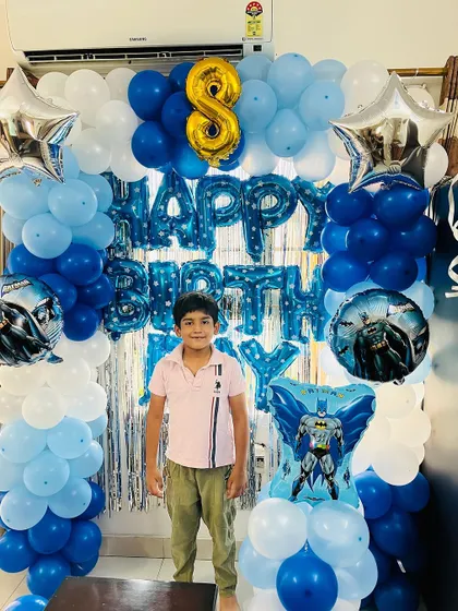 A clear, full shot of the Batman birthday backdrop, showing the arrangement of the balloon columns and the foil banner.